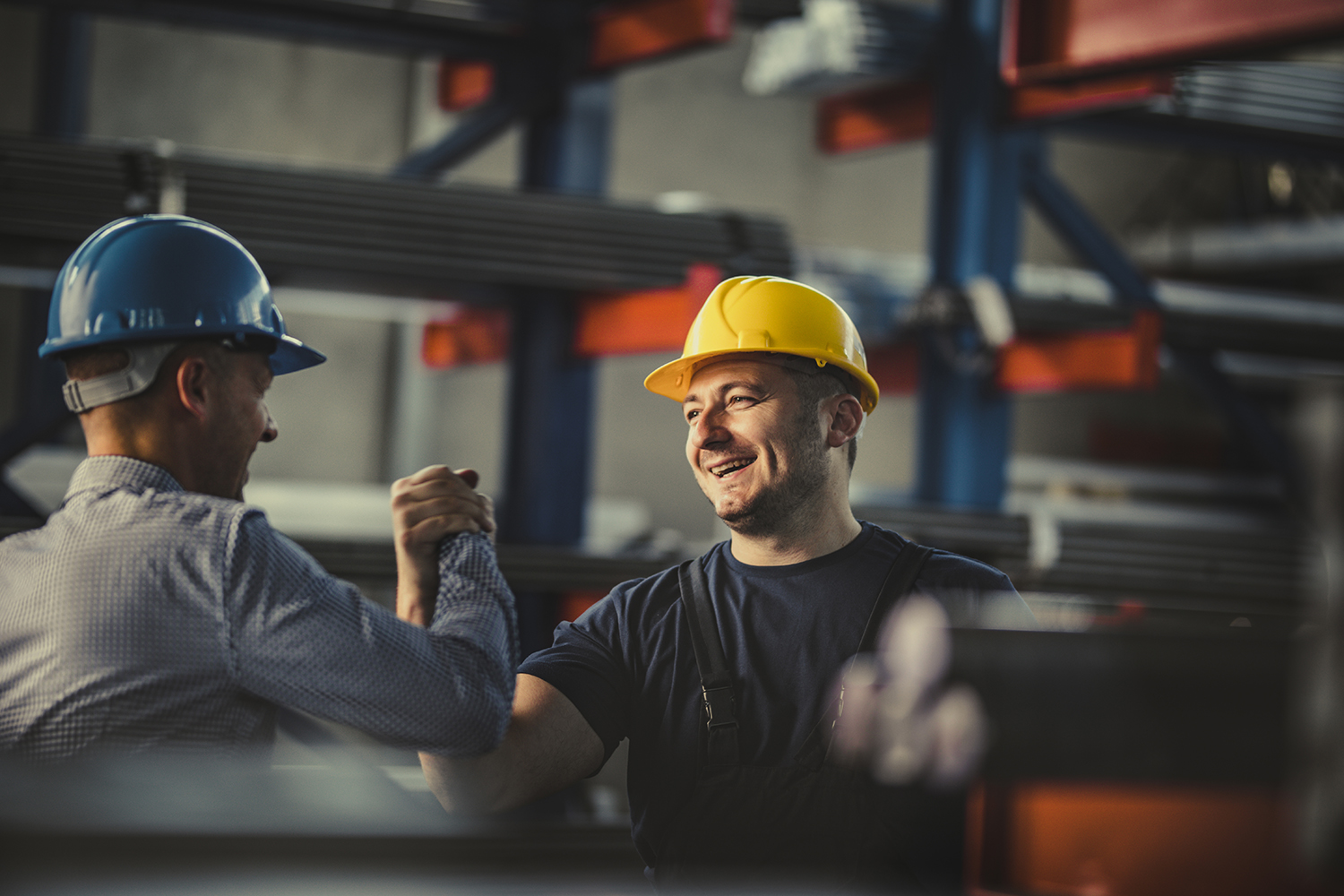 workers in hard hats giving a high five