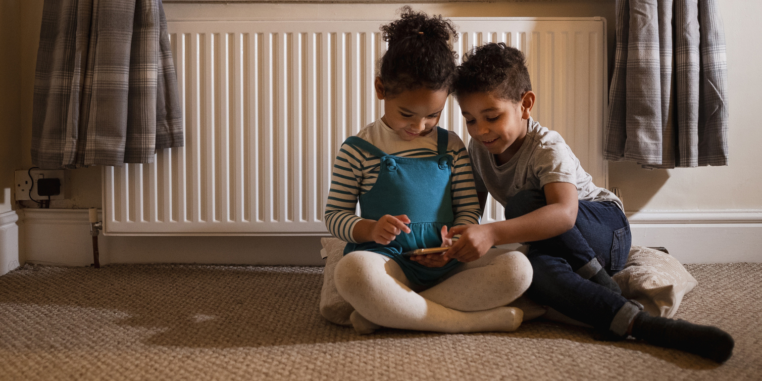 kids in front of a radiator