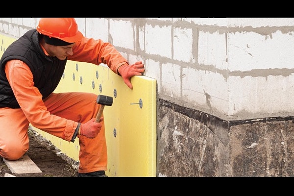 insulation being secured to wall