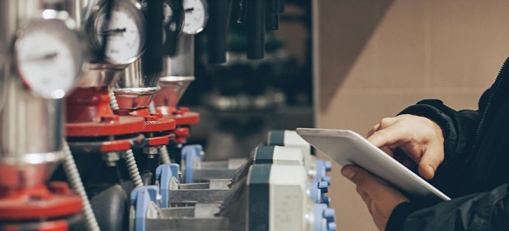 person inspecting industrial equipment