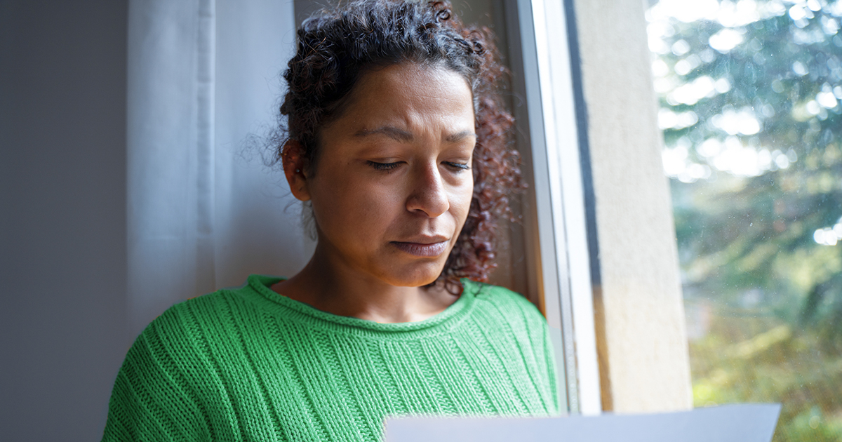 A woman looking concerned about an energy bill