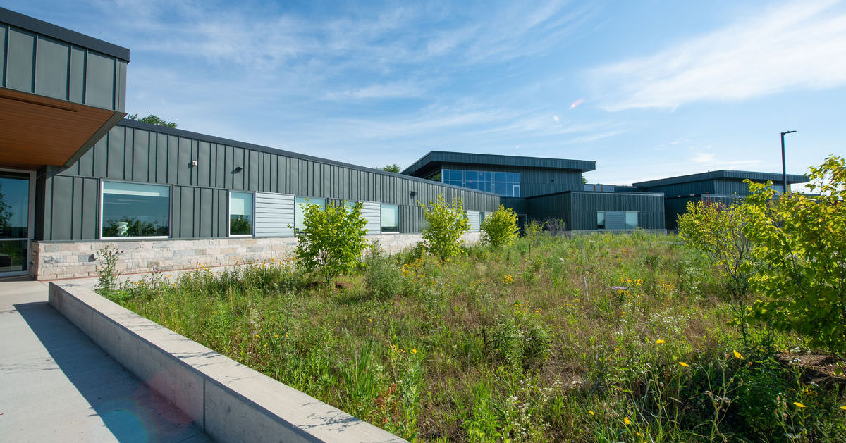 The exterior of a school with plenty of green grass