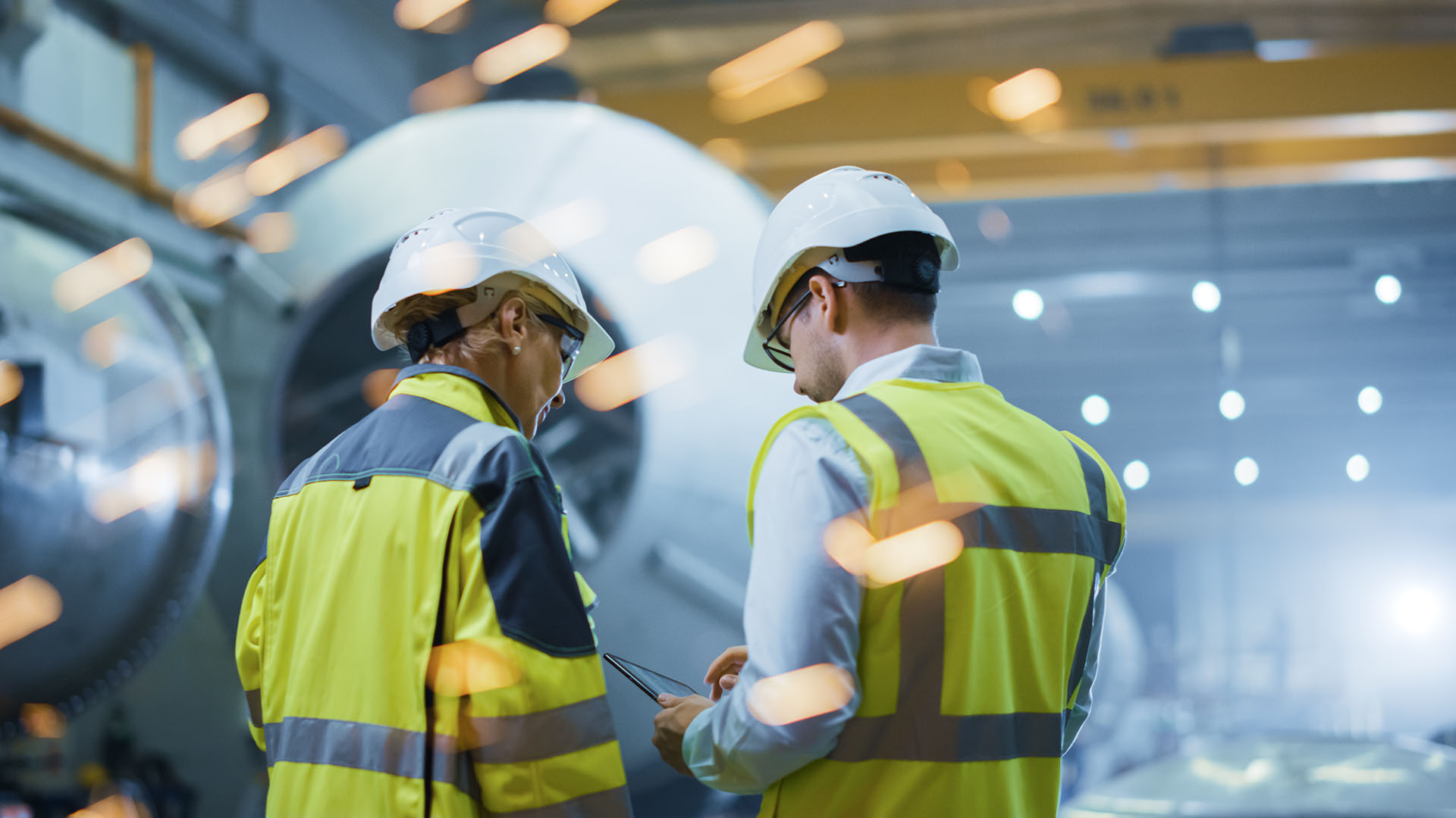 Two people standing in construction area