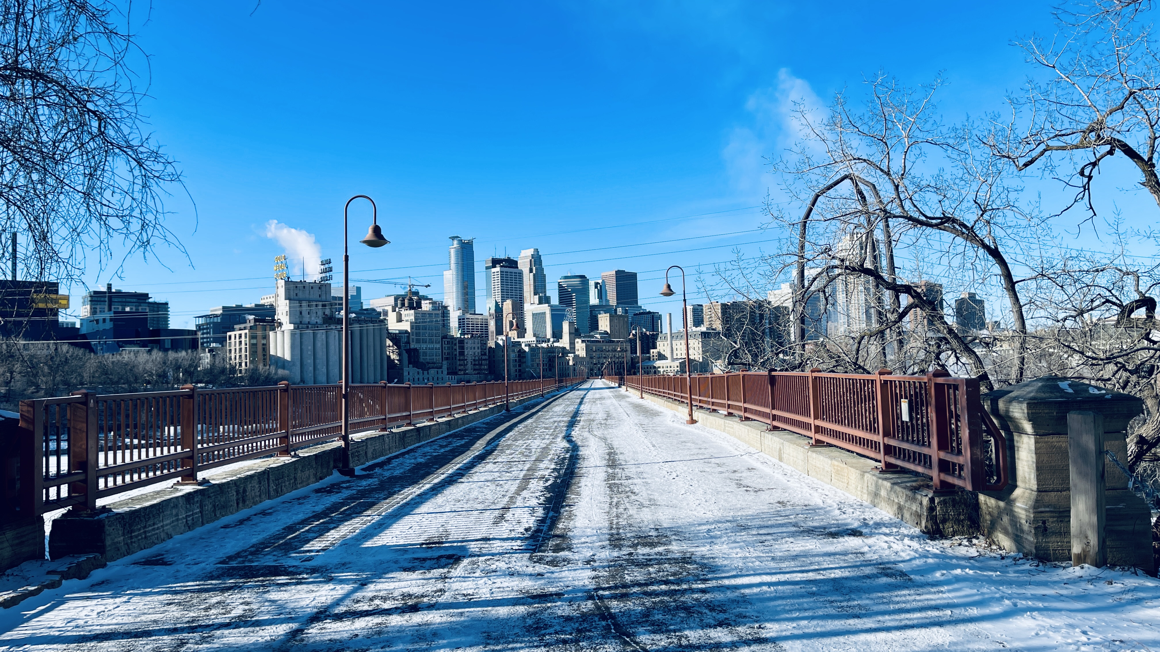 A shot of downtown Minneapolis from across a snowy bridge