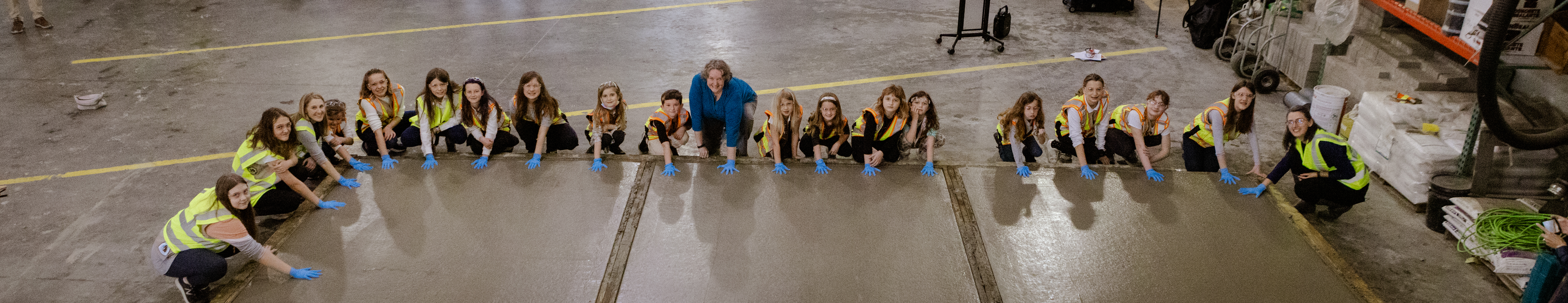 The troop holding their hands over freshly poured concrete