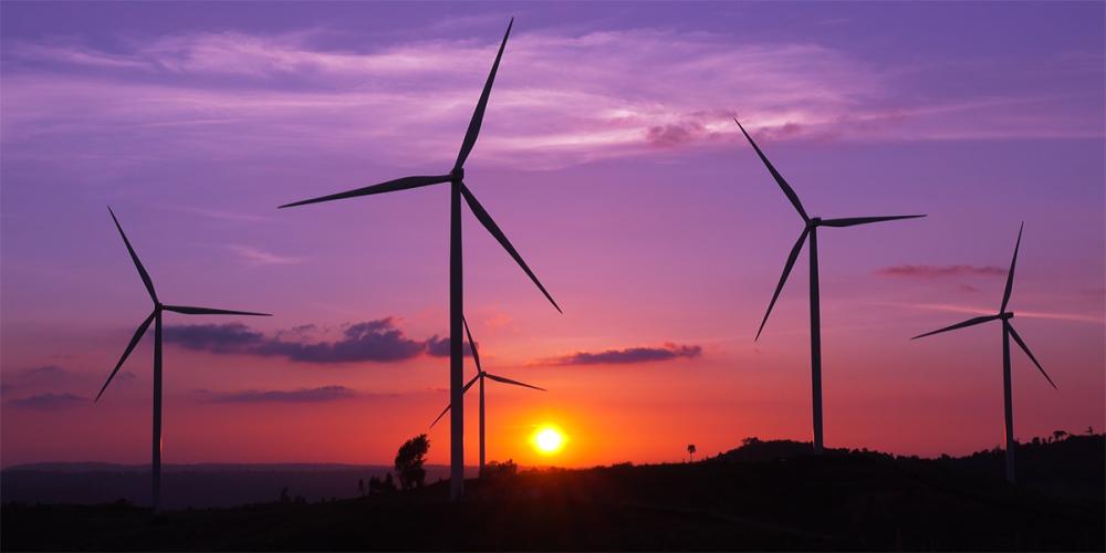 Wind turbines in front of a sunrise